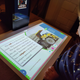 A photo of a kid looking at the Amazon Glow's projection of a story book